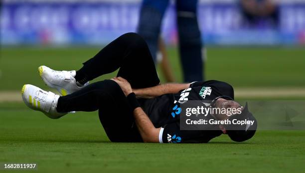 Tim Southee of New Zealand lies on the ground after injuring his thumb while attempting a catchduring the 4th Metro Bank One Day International...