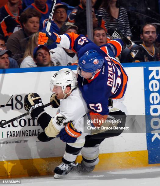 Brooks Orpik of the Pittsburgh Penguins checks Casey Cizikas of the New York Islanders during the second period in Game Four of the Eastern...