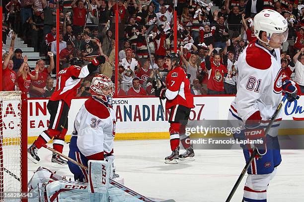 Kyle Turris of the Ottawa Senators celebrates a goal with teammate Daniel Alfredsson Carey Price and Raphael Diaz of the Montreal Canadiens react in...