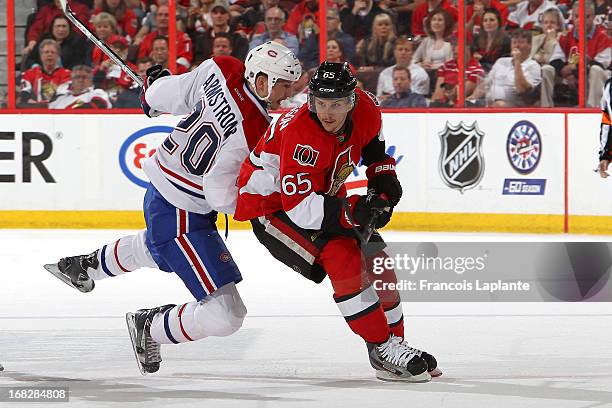 Erik Karlsson of the Ottawa Senators skates against Colby Armstrong of the Montreal Canadiens in Game Three of the Eastern Conference Quarterfinals...