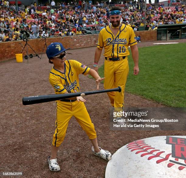 Brockton, Mass., August 16, 2023: Mark Swaggy Lane a Make a Wish Kid, practices his bat moves with Banana Alex Ziegler as the Savannah Bananas take...