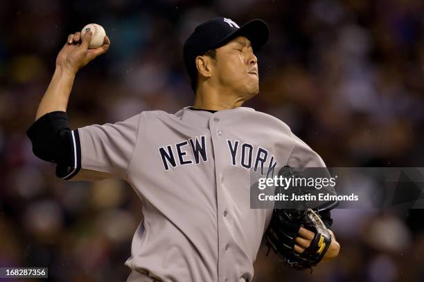 Hiroki Kuroda of the New York Yankees delivers to home plate during the third inning against the Colorado Rockies at Coors Field on May 7, 2013 in...