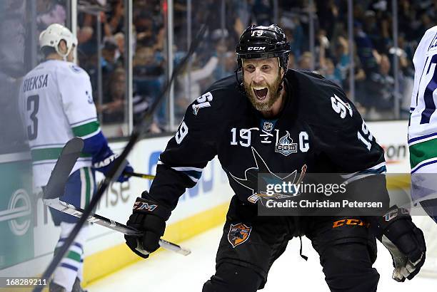 Joe Thornton of the San Jose Sharks celebrates after Patrick Marleau scored the game winning goal against Kevin Bieksa and the Vancouver Canucks in...