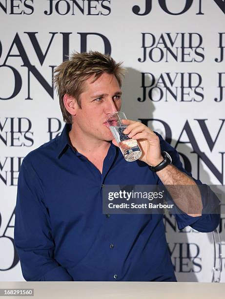 Celebrity Chef Curtis Stone drinks a glass of water at the launch of his book "What's For Dinner" at David Jones Bourke Street on May 8, 2013 in...