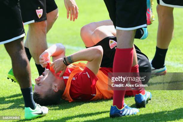 Alexandru Maxim lies on the pitch during a VfB Stuttgart training session at the club's premises on May 8, 2013 in Stuttgart, Germany.