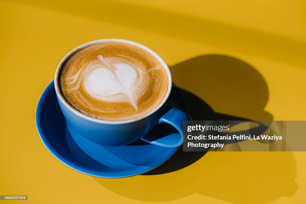 Cuo of Cappuccino On Yellow Table