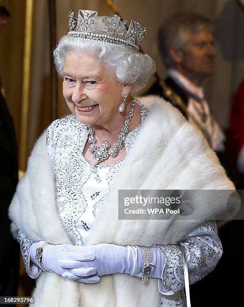 Queen Elizabeth II smiles as she leaves the State Opening of Parliament at the House of Lords on May 8, 2013 in London, England. Queen Elizabeth II...
