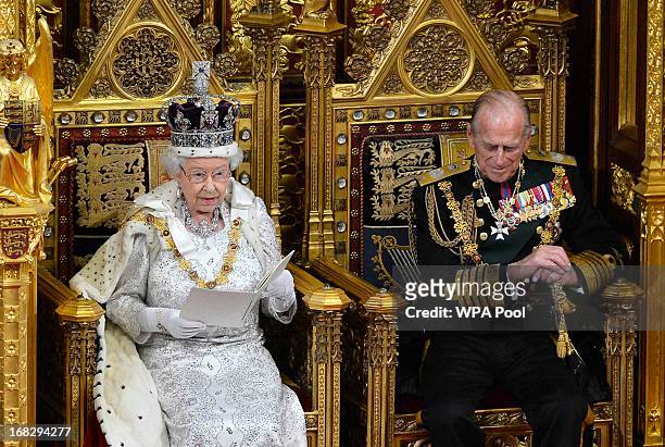 Britain's Queen Elizabeth II delivers her speech next to Prince Phillip, Duke of Edinburgh at the State Opening of Parliament on May 8, 2013 in...