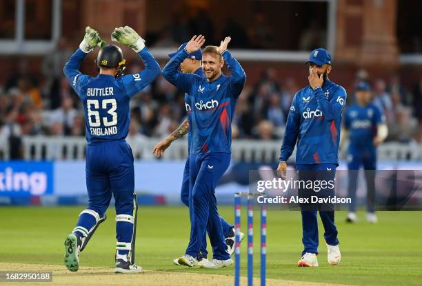 Liam Livingstone of England celebrates taking the wicket of Glenn Phillips of New Zealand with teammates during the 4th Metro Bank ODI between...