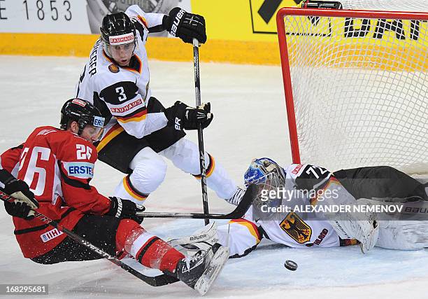 Germany's defender Justin Krueger vies with Austria's forward Thomas Vanek in front of Germany's goalie Rob Zepp during a preliminary round game...