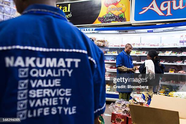 Employees assist customers in the food section of a Nakumatt department store at Westgate Mall in Nairobi, Kenya, on Friday, May 3, 2013. Nakumatt...