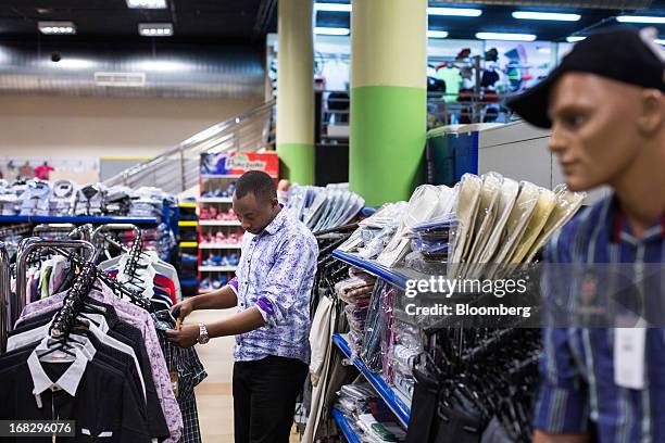 Customer browses men's clothing on display at the Nakumatt department store at Westgate Mall in Nairobi, Kenya, on Friday, May 3, 2013. Nakumatt...
