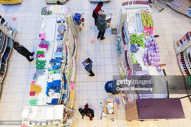 Customers browse goods for sale in the toiletries section of the Nakumatt department store at Westgate Mall in Nairobi, Kenya, on Friday, May 3,...