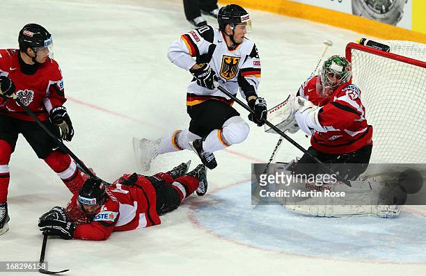 Patrick Hager of Germany fails to score over Bernhard Starkbaum , goaltender of Austria battle for the puck during the IIHF World Championship group...