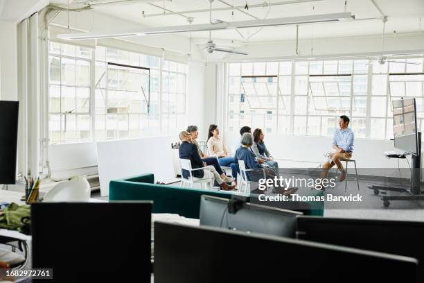 wide shot colleagues in project meeting in conference area in office - plano geral imagens e fotografias de stock