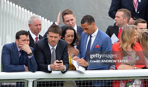 Manchester United's English defender Rio Ferdinand signs an autograph next to Manchester United's English midfielder Michael Carrick at the Chester...