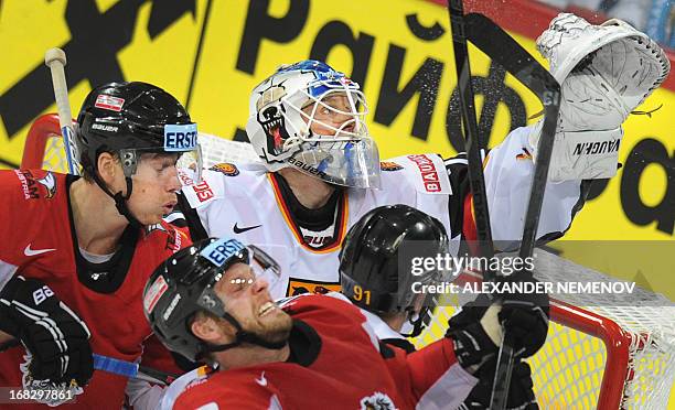 Austrian players attack Germany's goalie Rob Zepp during a preliminary round game Austria vs Germany of the IIHF International Ice Hockey World...