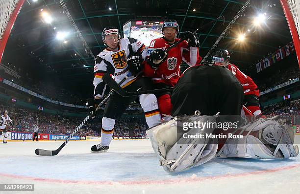 Florian Iberer of Austria baatles for position with Michael Wolf of Germany in front of the net during the IIHF World Championship group H match...