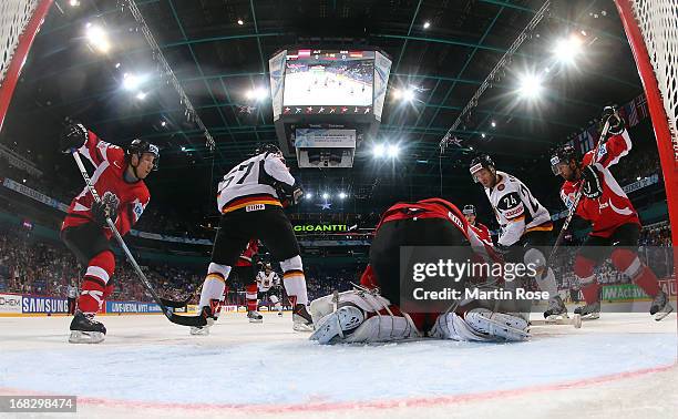 Berhard Starkbaum , goaltender of Austria makes a save on Andre Rankel of Germany during the IIHF World Championship group H match between Austria...