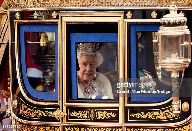 Queen Elizabeth II travels in a horse drawn carriage from Buckingham Palace to attend the State Opening of Parliament on May 8, 2013 in London,...