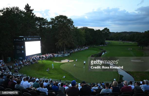 General view as Thomas Bjorn of Denmark, Nicolas Colsaerts of Belgium and Stephen Gallacher of Scotland play the 18th green on Day Two of the BMW PGA...