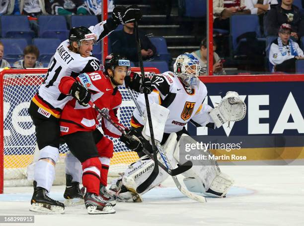 Raphael Herburger of Austria battles for position with Torsten Ankert of Germany during the IIHF World Championship group H match between Austria and...