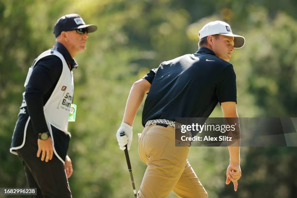 William Mouw of the United States and his caddie watch his shot on the 16th hole during the second round of the Simmons Bank Open for the Snedeker...