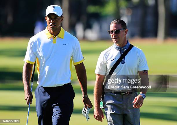 Tiger Woods of the USA walks with his coach Sean Foley during a practice round for THE PLAYERS Championship at THE PLAYERS Stadium course at TPC...