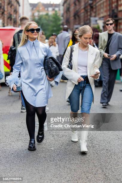 Guest wears blue button shirt, black bag outside Edward Crutchley during London Fashion Week September 2023 on September 15, 2023 in London, England.