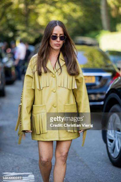 Idalia Salsamendi wears yellow jacket with fringes, heels outside Bora Aksu during London Fashion Week September 2023 on September 15, 2023 in...