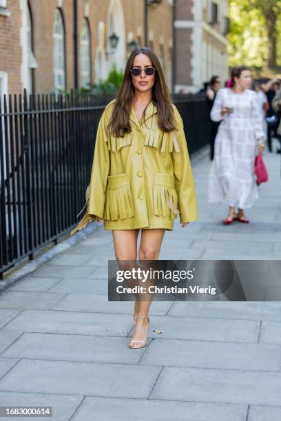 Idalia Salsamendi wears yellow jacket with fringes, heels outside Bora Aksu during London Fashion Week September 2023 on September 15, 2023 in...