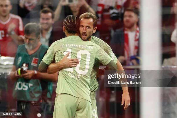 Harry Kane of Bayern Munich celebrates with Leroy Sane of Bayern Munich after scoring the team's first goal during the Bundesliga match between FC...