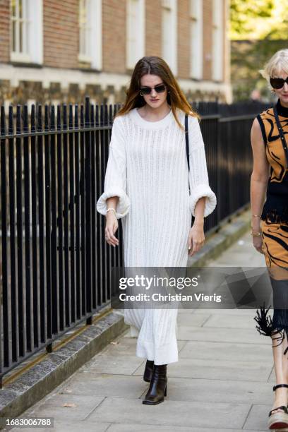Guest wears white dress with long sleeves outside Bora Aksu during London Fashion Week September 2023 on September 15, 2023 in London, England.