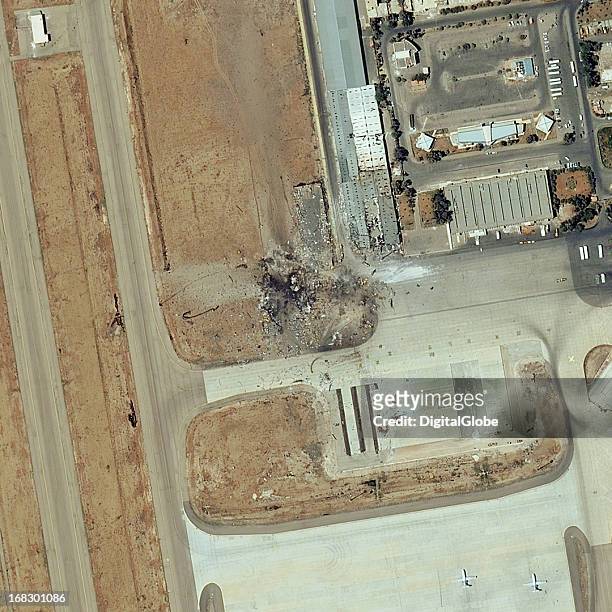This is a satellite image of a destroyed warehouse and storage buildings at Damascus International Airport that were struck by a reported military...