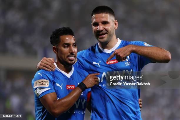 Aleksandar Mitrovic of Al Hilal celebrates with Salem Al-Dawsari of Al Hilal after scoring the team's first goal during the match between Al-Hilal...