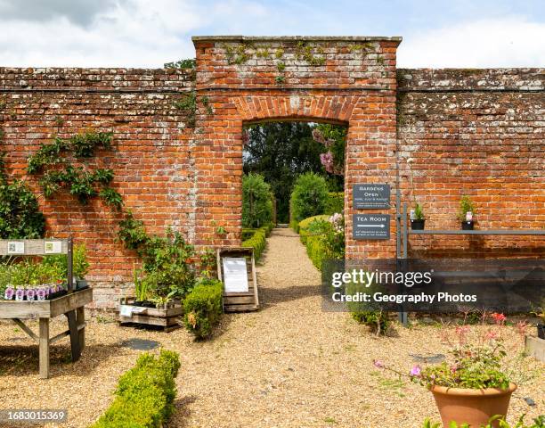 Red brick entrance to walled kitchen garden, Redisham Hall gardens and plant nursery, Redisham, Suffolk, England, UK.