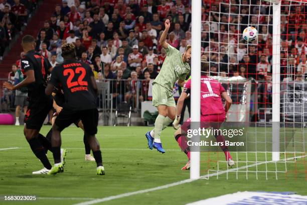 Harry Kane of Bayern Munich scores the team's first goal during the Bundesliga match between FC Bayern München and Bayer 04 Leverkusen at Allianz...