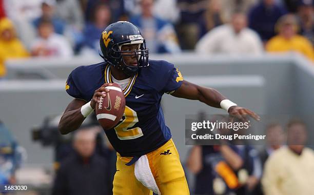 Quarterback Rasheed Marshall of the West Virginia University Mountaineers looks for an open man against the University of Miami Hurricanes during a...