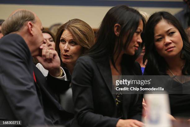 Rep. Louie Gohmert talks with Rep. Michele Bachmann while they sit Dorothy Narvaez-Woods , widow of former Navy SEAL Tyrone Woods who was killed in...