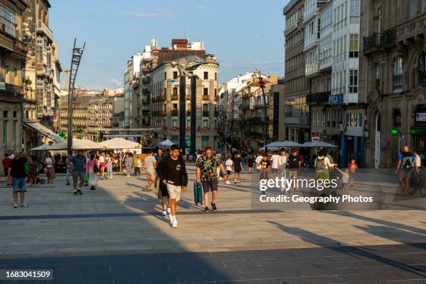 People in pedestrianized central square, Praza Porto do Sol plaza, city center of Vigo, Galicia, Spain.