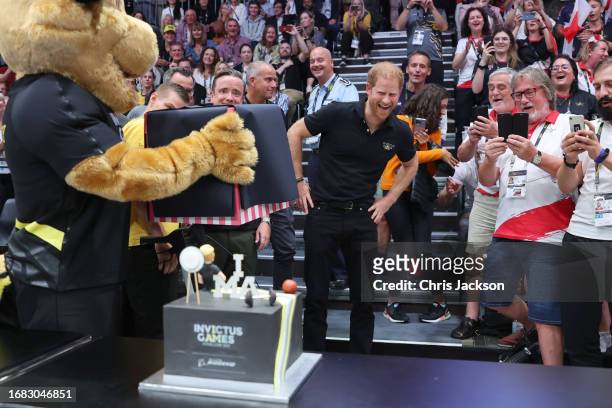 Prince Harry, Duke of Sussex is presented with a Invitus Games themed cake for his 39th birthday during the sitting volleyball finals at the Merkur...