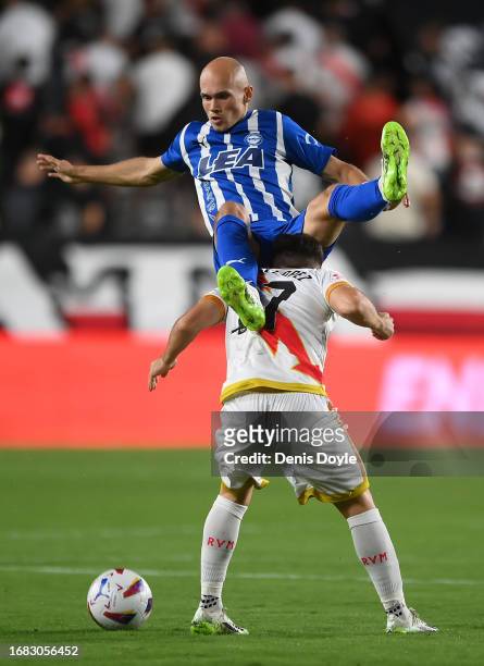 Jon Guridi of Deportivo Alaves is tackled by Unai Lopez of Rayo Vallecano during the LaLiga EA Sports match between Rayo Vallecano and Deportivo...