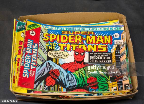 Box of Super Spider-Man Titans comics on display in auction room, UK.