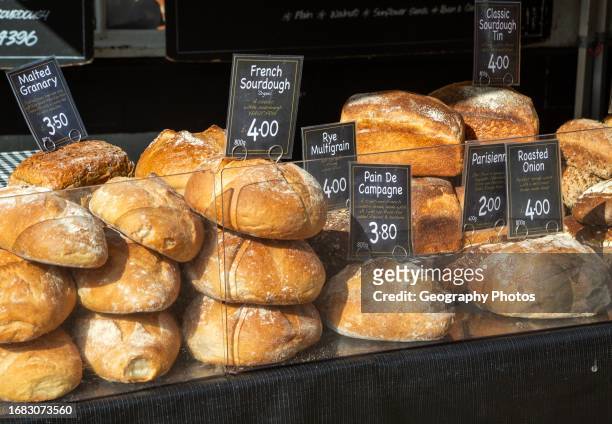 Fresh loaves of artisan bread on sale at street market stall, BrownBread bakery, Woodbridge, Suffolk, England, UK.