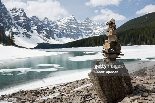 inukshuk, stacked stones at moraine lake - inukshuk stock pictures, royalty-free photos & images