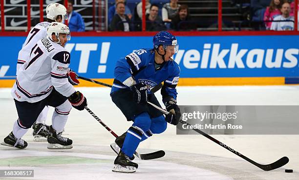 Aaron Palushaj of USA and Juha Hytonen of Finland battle for the puck during the IIHF World Championship group H match between USA and Finland at...