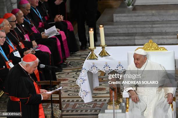 Pope Francis listens to the welcome speech of Marseille's Archbishop and Cardinal Jean-Marc Aveline prior to take part in a Marian prayer with the...