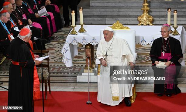 Pope Francis listens to the welcome speech of Marseille's Archbishop and Cardinal Jean-Marc Aveline prior to take part in a Marian prayer with the...
