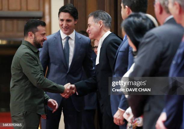 Ukrainian President Volodymyr Zelensky, with Prime Minister Justin Trudeau , shake hands with House of Commons Speaker Anthony Rota during a ceremony...