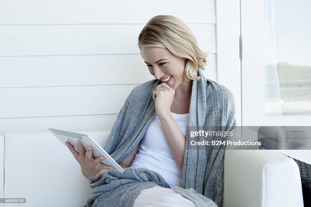 Happy Woman Looking At Digital Tablet